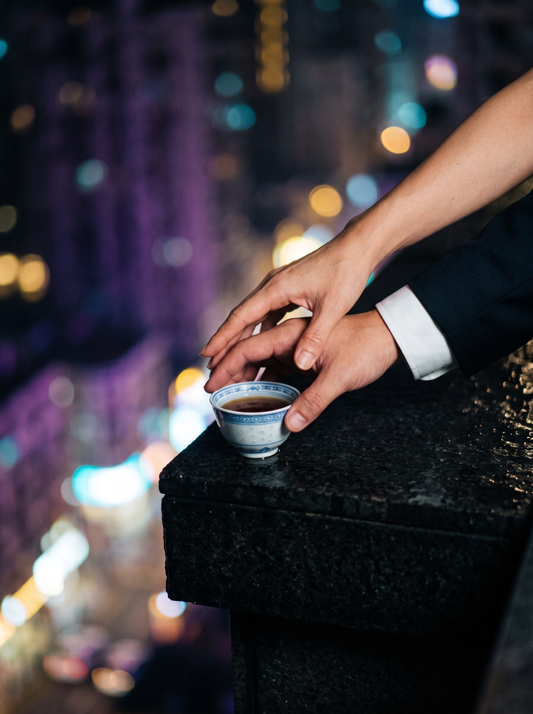 A woman guides Ho Chan’s hand toward a teacup on the wet rooftop ledge