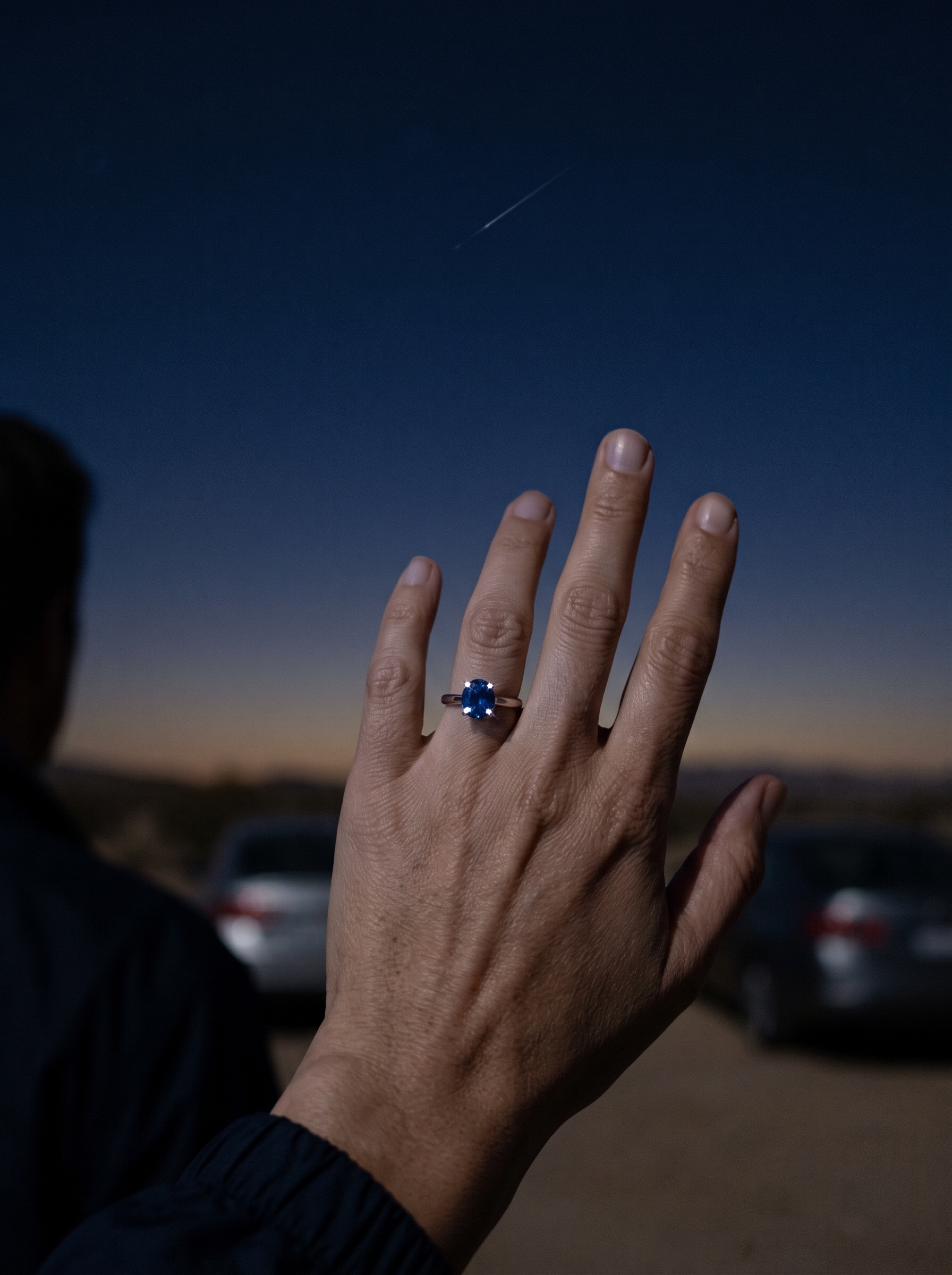 Maria raising her sapphire ring toward a shooting star