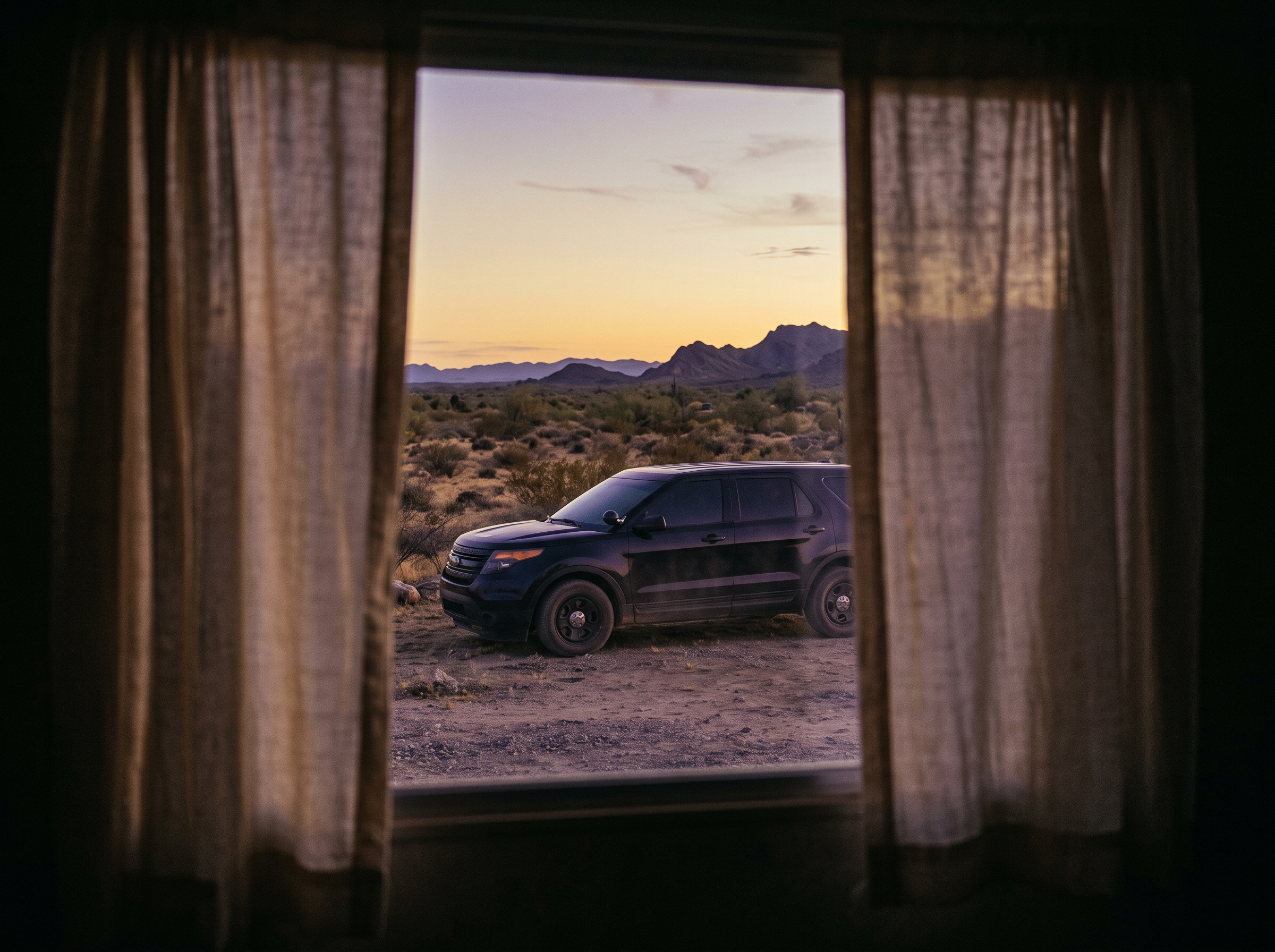 A black SUV waiting outside Tina’s mobile home at dusk