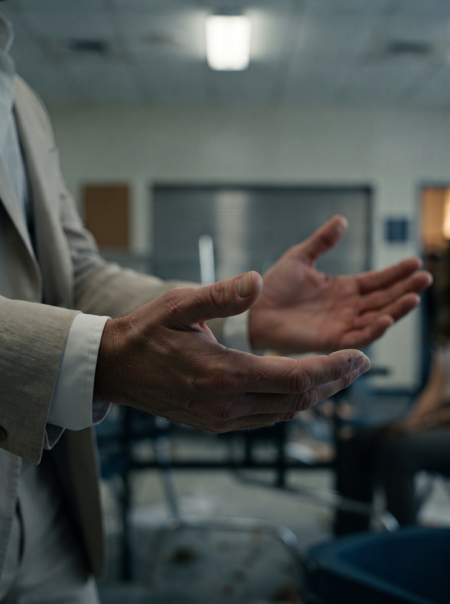 Close view of Mac Allen holding both hands open in surrender