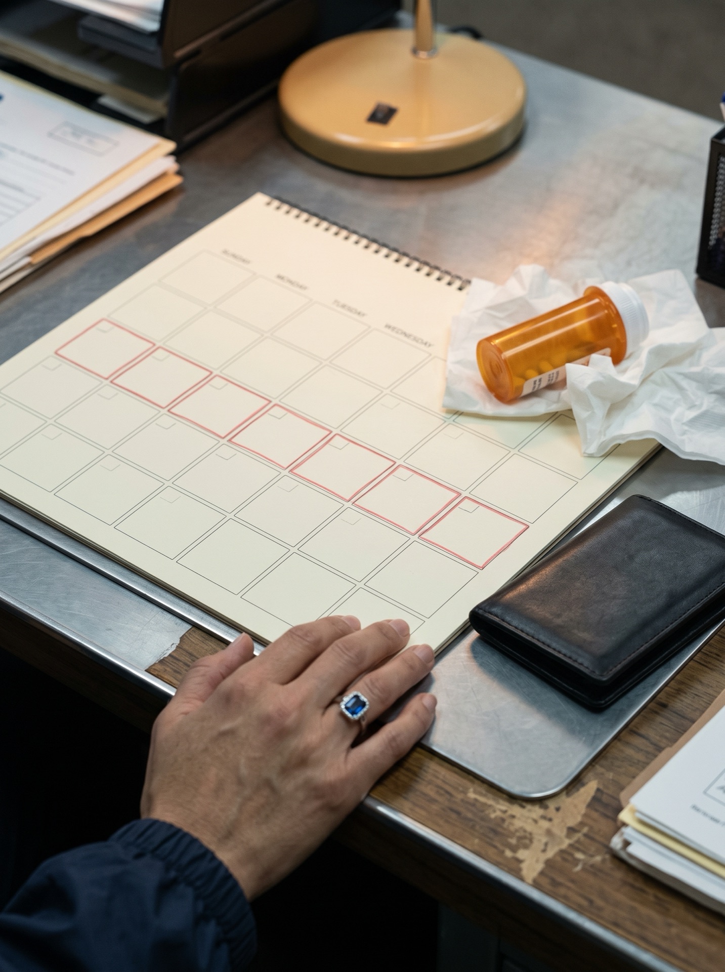 A weekly calendar beside Maria Garcia’s pills and wallet